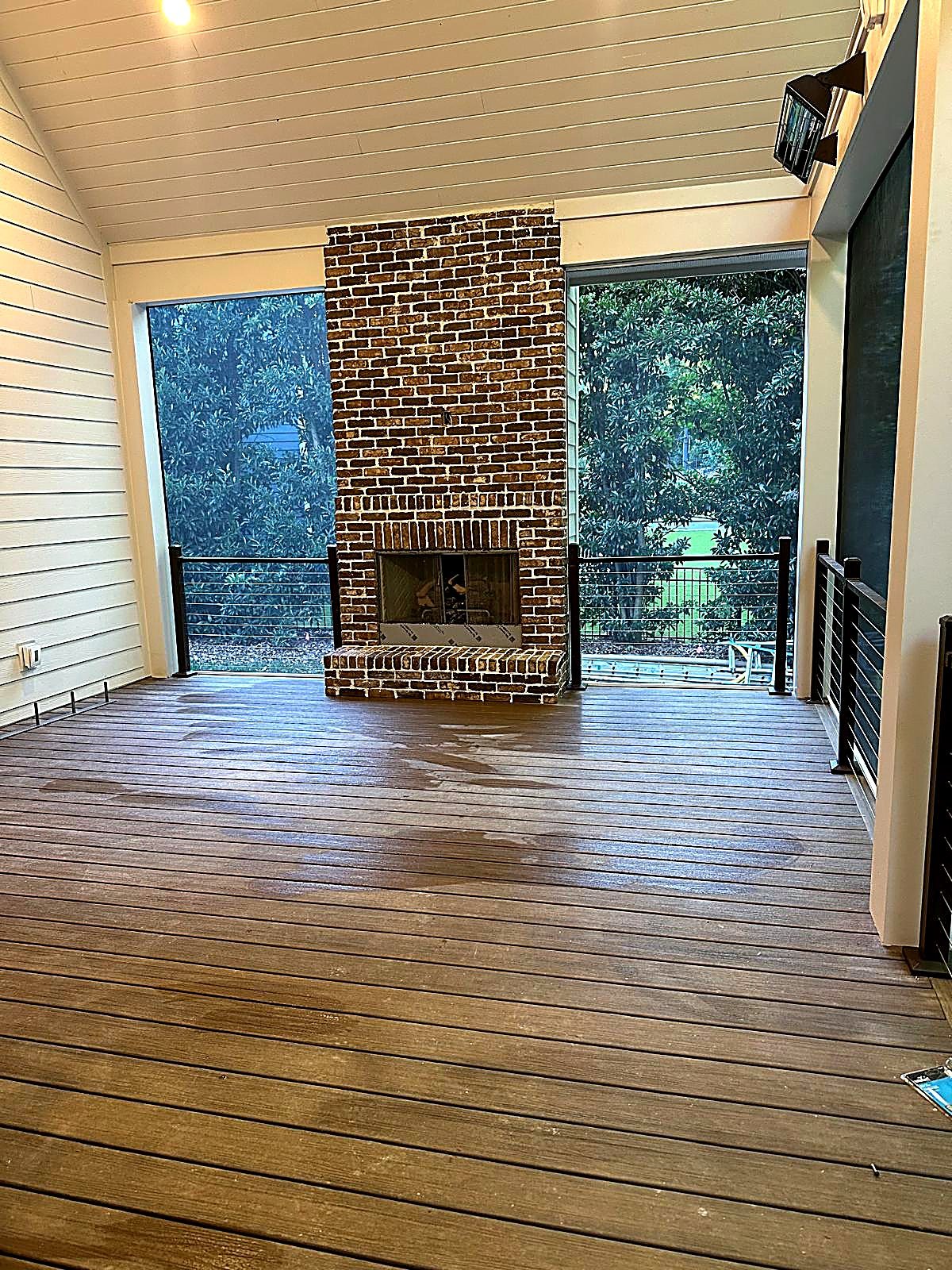 Outdoor brick fireplace on covered porch